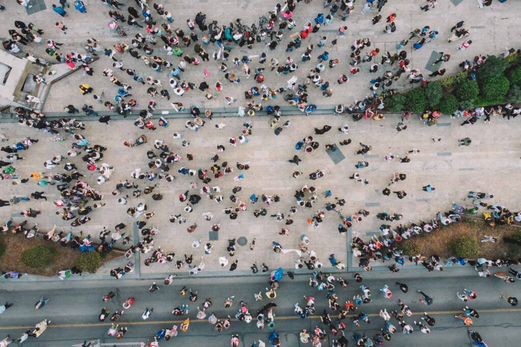 overhead street photo with a large group of people walking