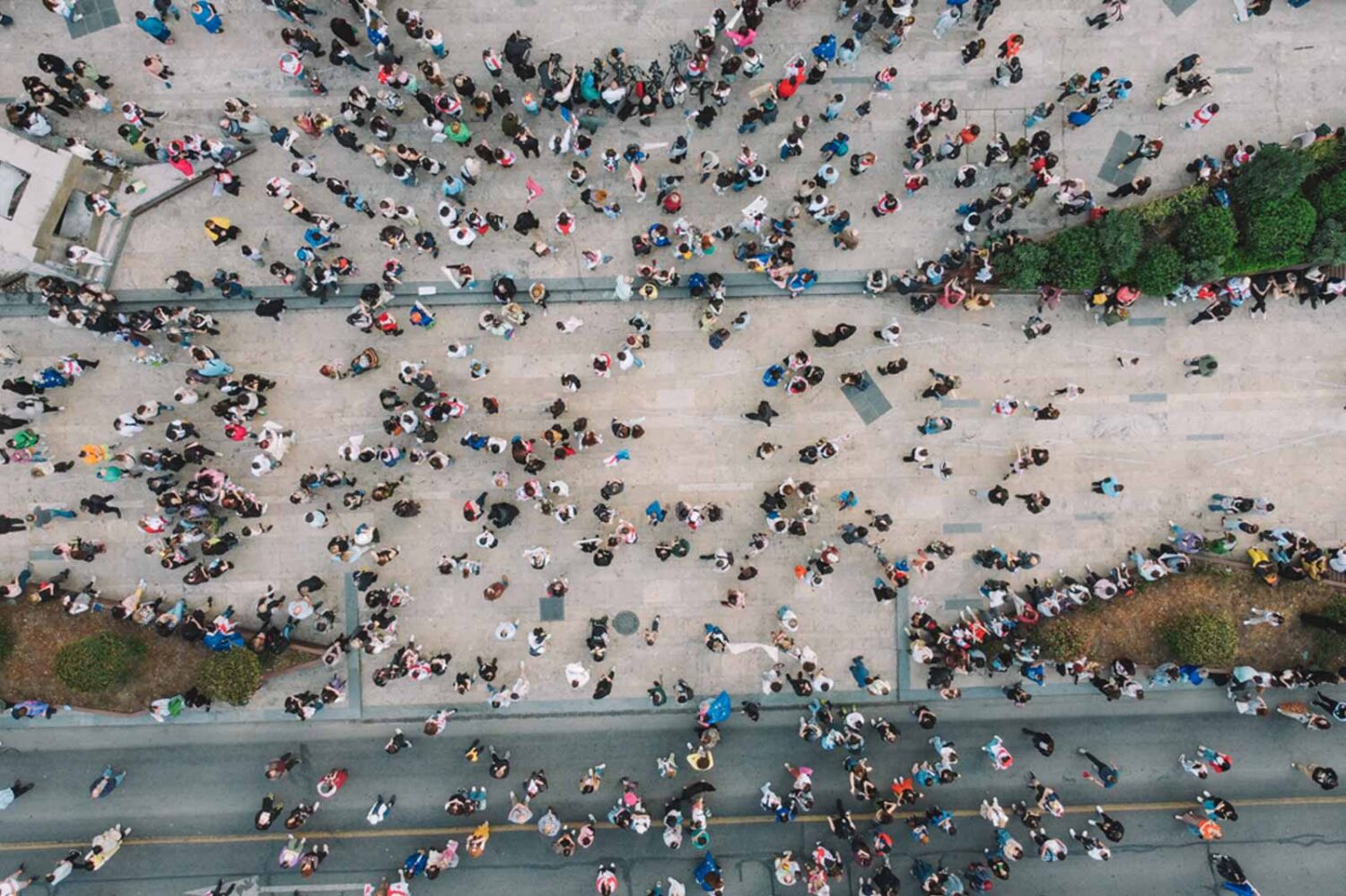 overhead street photo with a large group of people walking