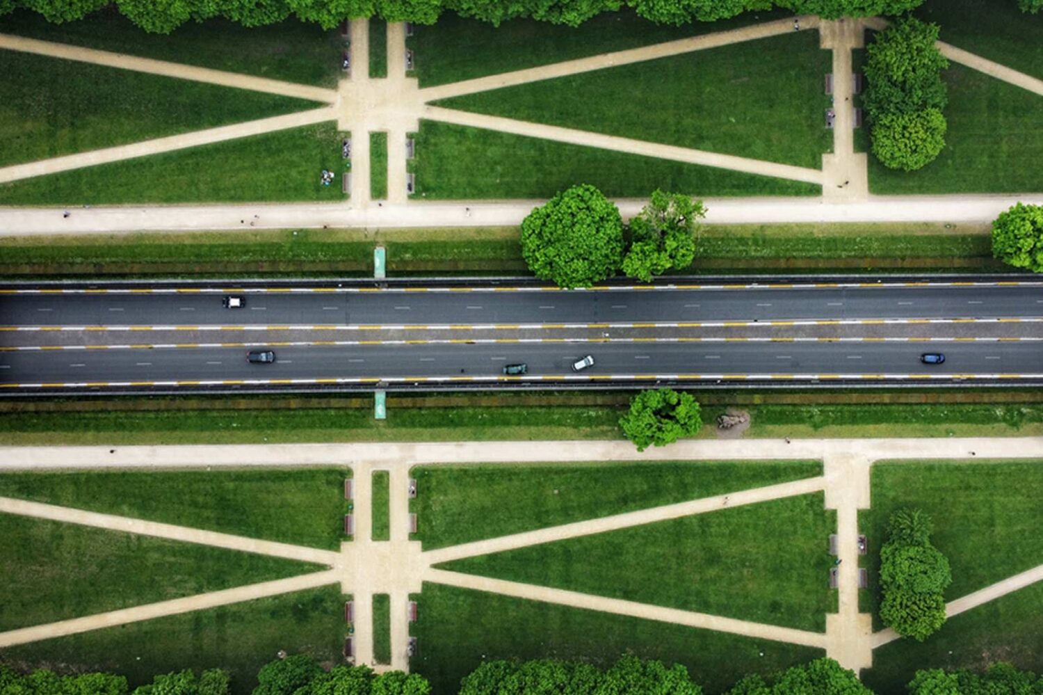 overhead photo of road and green landscape surrounding