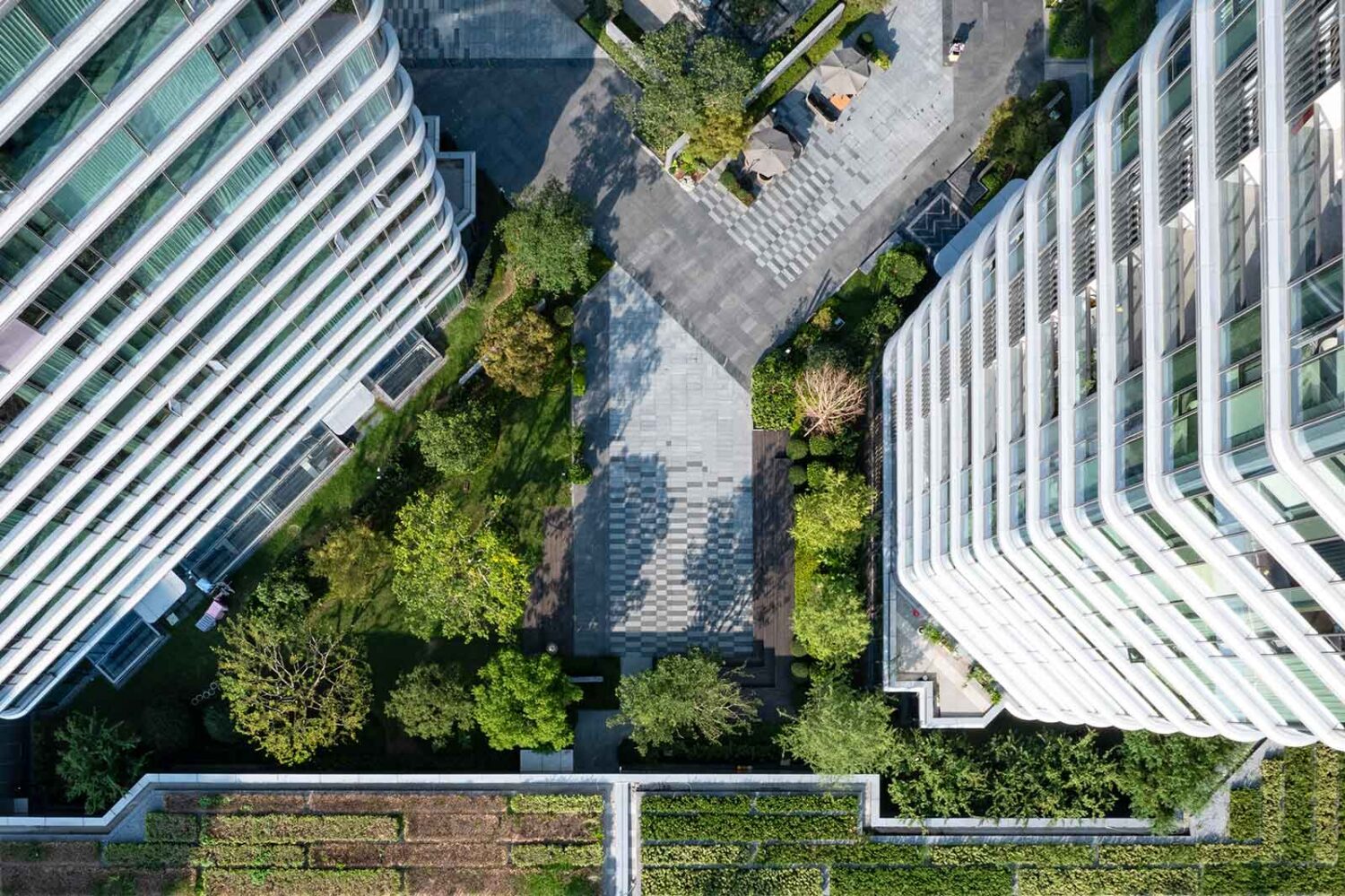 aerial view of tall commercial buildings with park in between