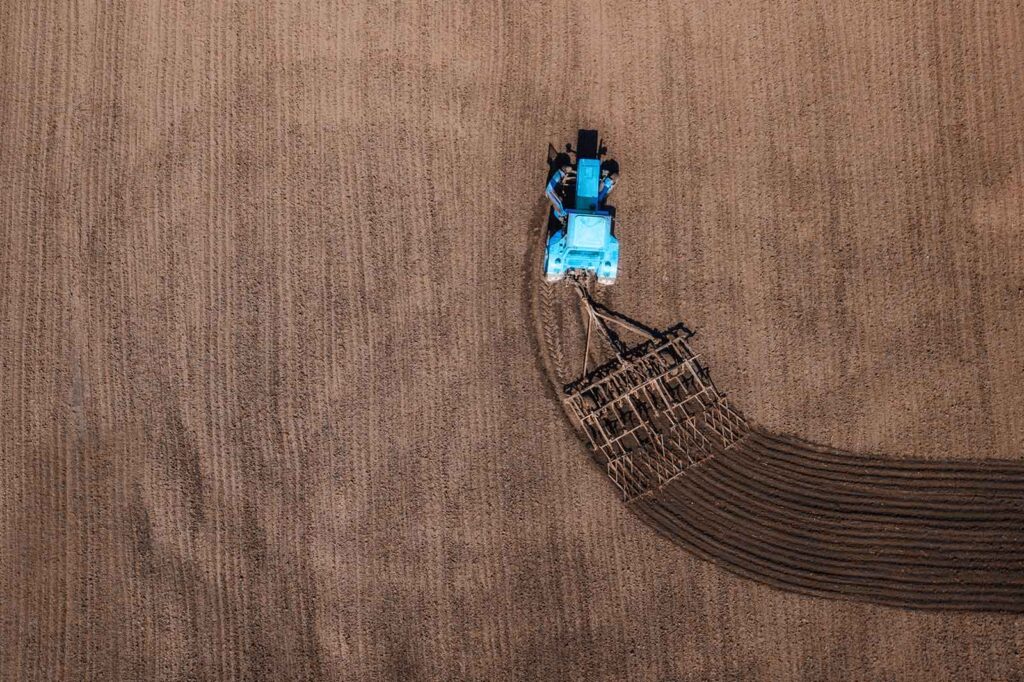 aerial view of tractor plowing field